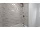 Close-up of shower with white marble-look tile and modern fixtures at 2001 Rolesville Rd, Wake Forest, NC 27587