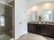 Bathroom showcasing a glass-enclosed shower and double vanity with granite countertop at 2027 October Dr, Durham, NC 27703