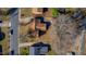 An aerial view of a home highlighting the roofline, mature trees, and surrounding neighborhood at 206 Eastway Ln, Graham, NC 27253
