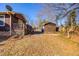 View of the house's backyard showing the large yard and detached shed at 206 Eastway Ln, Graham, NC 27253