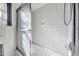 Bright tiled tub/shower combo with sliding door and white tile at 206 Eastway Ln, Graham, NC 27253