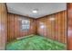 Bedroom with wood paneling and a window looking out over the outdoors at 206 Eastway Ln, Graham, NC 27253