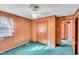 Bedroom featuring wood walls, carpet, a window, and a closet at 206 Eastway Ln, Graham, NC 27253