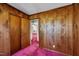 Bedroom with paneled walls, plush carpeting, and a closet at 206 Eastway Ln, Graham, NC 27253