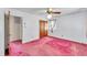 Bright bedroom featuring light walls, ceiling fan, and pink carpeting at 206 Eastway Ln, Graham, NC 27253