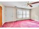 Bright bedroom with pink carpet, ceiling fan and large window with ample sunlight at 206 Eastway Ln, Graham, NC 27253