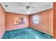 Bedroom features wood walls, carpet, a window, and a closet at 206 Eastway Ln, Graham, NC 27253