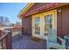 Inviting deck featuring French doors, a seating area, and a charming awning, perfect for outdoor relaxation at 206 Eastway Ln, Graham, NC 27253