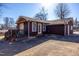 A charming home exterior featuring a deck with awning, French doors, and a well-maintained yard at 206 Eastway Ln, Graham, NC 27253