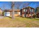 Charming two-story home with brick and wood siding, attached garage and a well-manicured front lawn at 206 Eastway Ln, Graham, NC 27253
