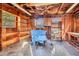 Garage with a ceiling fan, wooden walls, shelves, and tools at 206 Eastway Ln, Graham, NC 27253