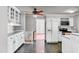 Updated kitchen with white cabinets, stainless steel appliances, and tiled floor at 206 Eastway Ln, Graham, NC 27253