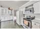 Functional kitchen with white appliances, lots of storage, tile floors and a view to the stairs at 206 Eastway Ln, Graham, NC 27253