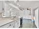 Spacious kitchen with white cabinetry, breakfast bar, and tile flooring extending into the dining area at 206 Eastway Ln, Graham, NC 27253