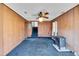 Spacious living room featuring wood paneling, stairs to the upper level, and a fireplace at 206 Eastway Ln, Graham, NC 27253