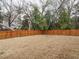 Large backyard with a wood privacy fence, backing to mature trees at 216 Cross St, Sanford, NC 27330