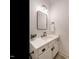 Bathroom features a modern vanity, updated lighting, and neutral color palette at 216 Cross St, Sanford, NC 27330