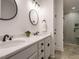 Bright bathroom features double vanity, modern lighting and a luxurious tiled walk-in shower at 216 Cross St, Sanford, NC 27330
