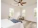 Bright bedroom featuring modern furniture, hardwood floors, and natural light from three windows at 216 Cross St, Sanford, NC 27330