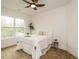 Well-lit bedroom with large window, neutral color scheme, and ceiling fan at 216 Cross St, Sanford, NC 27330