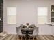 Bright dining area featuring modern chairs, dark wood table, and natural light from two windows at 216 Cross St, Sanford, NC 27330