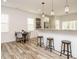 Open-concept kitchen and dining area with modern pendant lighting and hardwood floors at 216 Cross St, Sanford, NC 27330