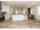 Open-concept kitchen with island, stainless steel appliances, and adjacent dining area at 216 Cross St, Sanford, NC 27330