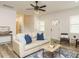 Bright open living room with luxury vinyl flooring, a modern ceiling fan, neutral color palette and lots of natural light at 216 Cross St, Sanford, NC 27330