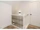 Stairway landing featuring white trim, black iron spindles and wood flooring at 216 Cross St, Sanford, NC 27330