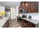 Modern kitchen featuring dark cabinets, stainless steel appliances, granite countertops and white subway tile backsplash at 220 Brook Farm Ln, Fuquay Varina, NC 27526