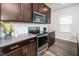 Close up of a stylish kitchen showcasing stainless steel appliances and granite countertops at 220 Brook Farm Ln, Fuquay Varina, NC 27526