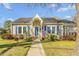 Charming single-story home with blue shutters, an American flag, and well-maintained landscaping at 227 Wildwood Ln, Burlington, NC 27215