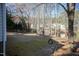 Large backyard with mature trees, a tire swing, and swing set near a pond at 2312 Knollwood Dr, Sanford, NC 27330