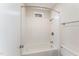 Clean and bright bathroom with a shower over the tub and updated fixtures at 25 Sandstone Ridge Dr, Durham, NC 27713