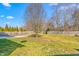 Spacious backyard featuring lush lawn, mature trees, and wooden fencing at 2506 Pepperstone Dr, Graham, NC 27253