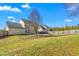 Lush backyard with mature trees and privacy fence; perfect for outdoor activities at 2506 Pepperstone Dr, Graham, NC 27253