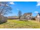Sprawling backyard with lawn, mature trees, and a privacy fence at 2506 Pepperstone Dr, Graham, NC 27253