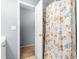 Bathroom with floral curtain and a door leading to another room at 2506 Pepperstone Dr, Graham, NC 27253