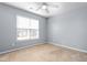 Bedroom features a window, neutral wall paint, and carpet flooring at 2506 Pepperstone Dr, Graham, NC 27253