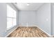 Bright bedroom with wood-look flooring and a large window for natural light at 2506 Pepperstone Dr, Graham, NC 27253