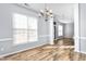 Dining room with wood-look flooring, chair rail detail, and a modern chandelier at 2506 Pepperstone Dr, Graham, NC 27253