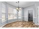 Dining area featuring hardwood floors, large windows, and decorative lighting fixture at 2506 Pepperstone Dr, Graham, NC 27253