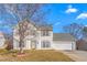 Charming two-story home with classic vinyl siding, mature trees, and two-car garage at 2506 Pepperstone Dr, Graham, NC 27253