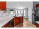 Kitchen featuring a stainless steel sink, appliances, and adjacent dining area at 2506 Pepperstone Dr, Graham, NC 27253