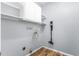Well-lit laundry room with storage shelves and washer/dryer hookups at 2506 Pepperstone Dr, Graham, NC 27253