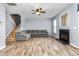 Spacious living room featuring a fireplace, wood-look floors, and a staircase at 2506 Pepperstone Dr, Graham, NC 27253
