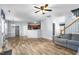 A spacious living room flows into the kitchen featuring hardwood floors and a comfortable gray sofa at 2506 Pepperstone Dr, Graham, NC 27253