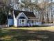 Charming blue home with a white picket fence and manicured lawn, creating a welcoming curb appeal at 2555 N Shiloh Rd, Garner, NC 27529