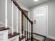 View of the staircase with wooden rails and a white door at 2555 N Shiloh Rd, Garner, NC 27529