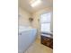 Functional laundry room with washer, dryer, and window at 256 Wembley Dr, Clayton, NC 27527